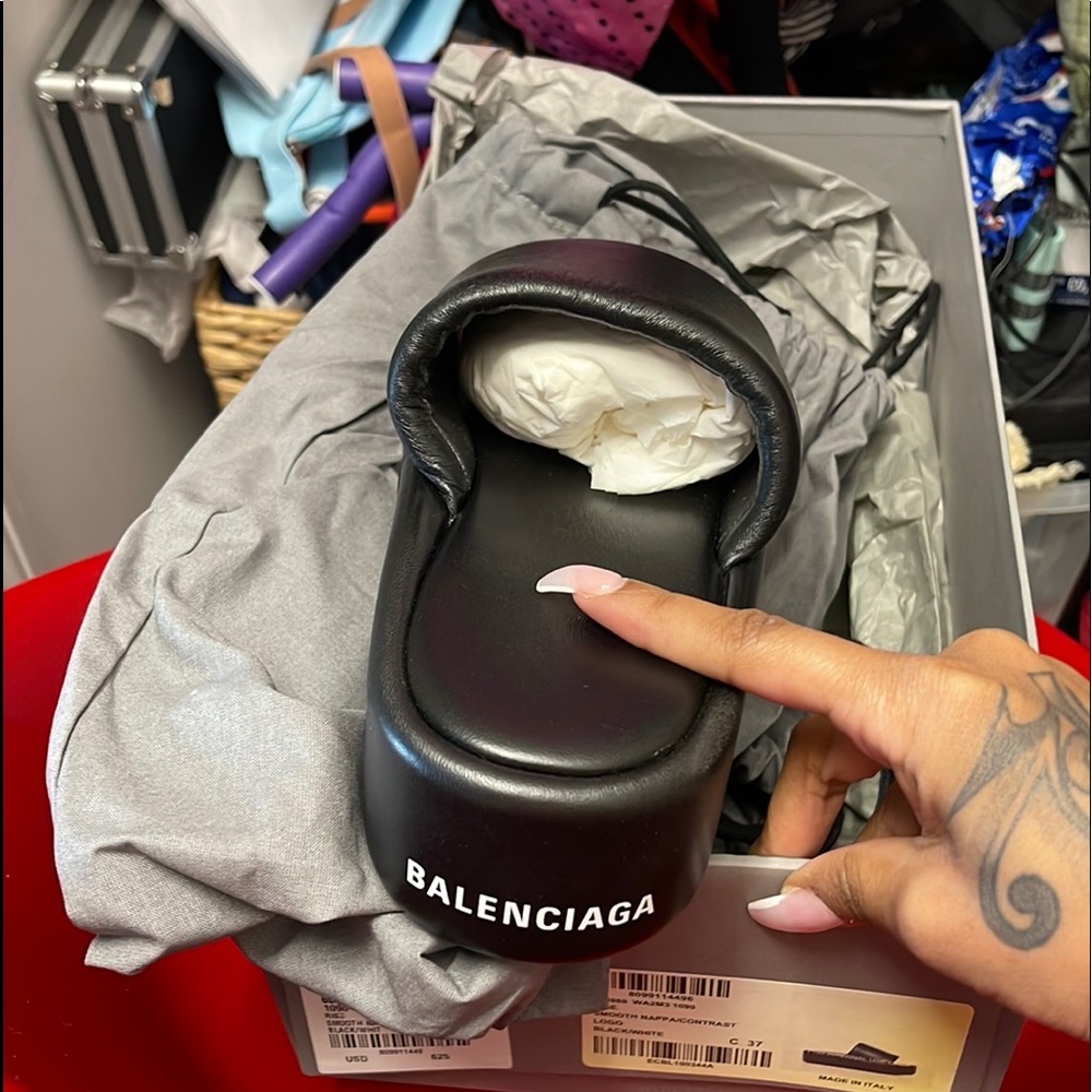 I am selling a pair of Balenciaga blacks high tops slippers leather material